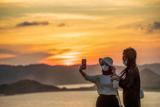 A couple taking a selfie at a tourist spot in Indonesia