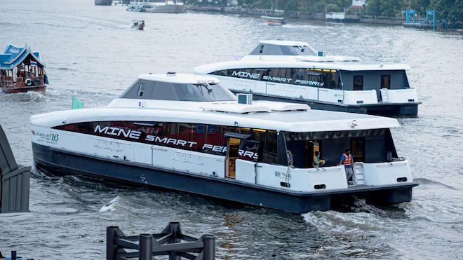Electric ferries along a river in Bangkok.