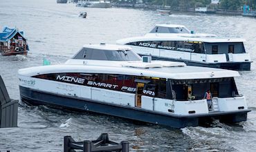 Electric ferries at a river in Bangkok, Thailand.