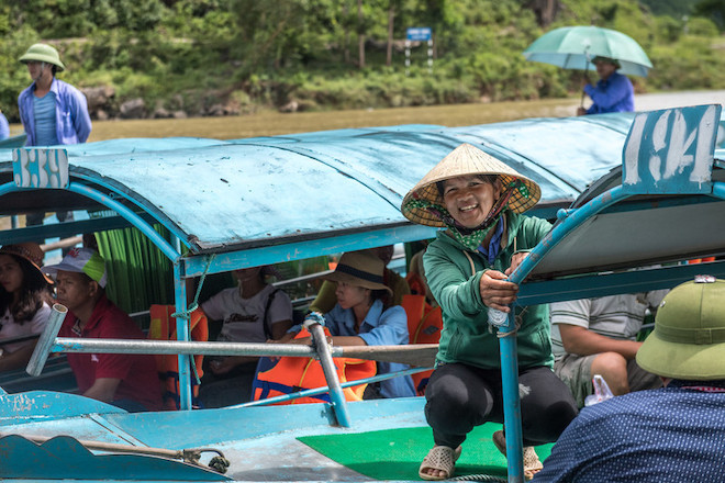 A tourist boat operator in Viet Nam poses for a photo.