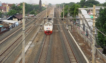 A train passing through neighborhoods in Jakarta