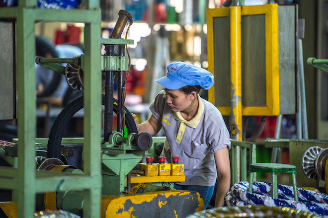 A woman working at a tire rubber factory.