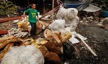 A man sorting through wastes in a recycling center.