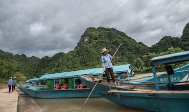 A boat operator prepares to tour customers along the Mekong River in Viet Nam.