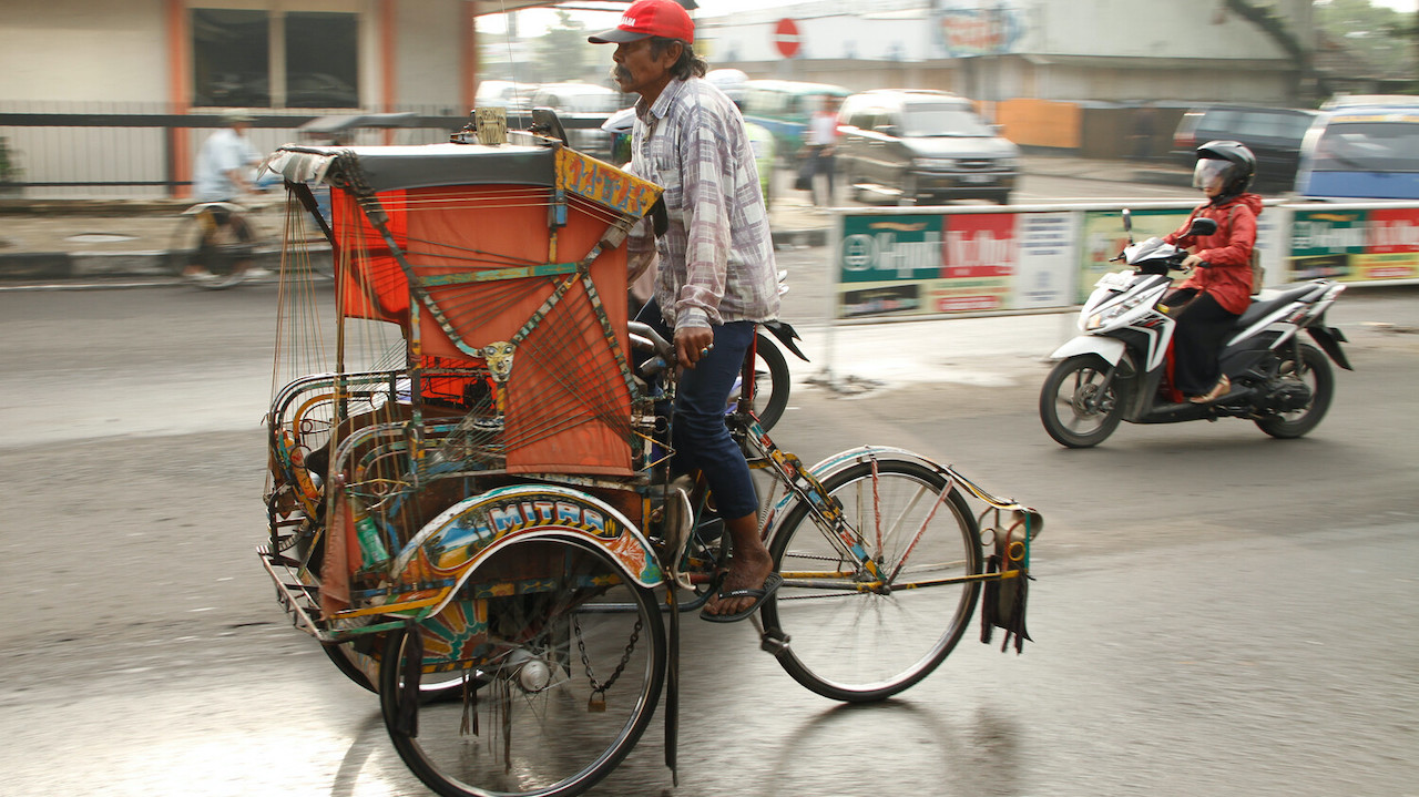 A man rides his pedicab along the streets of Bandung in West Java. Photo credit: ADB.