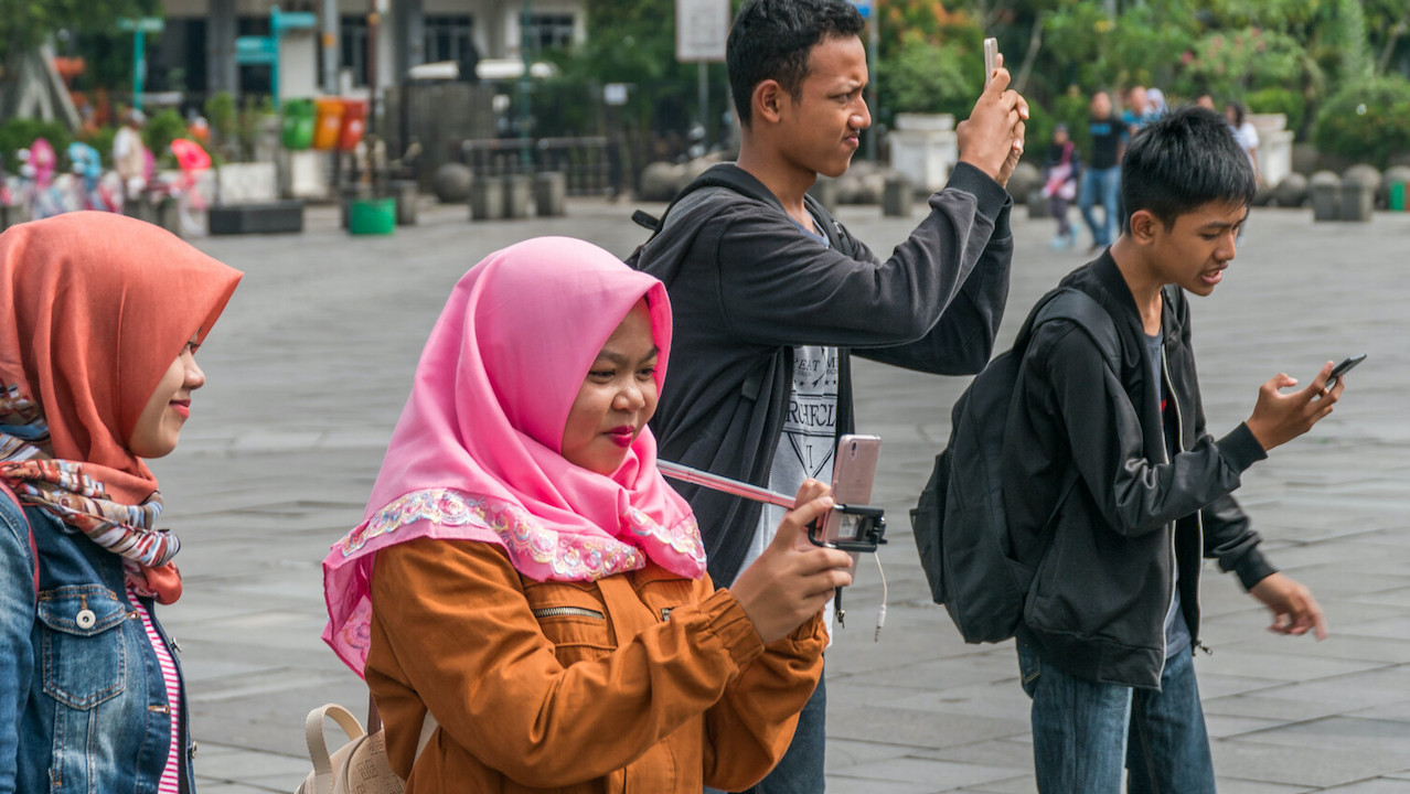 People enjoy themselves in a plaza in Indonesia..