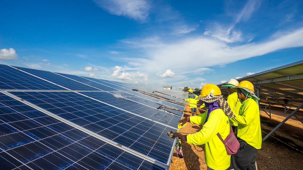 Workers cleaning solar panels.