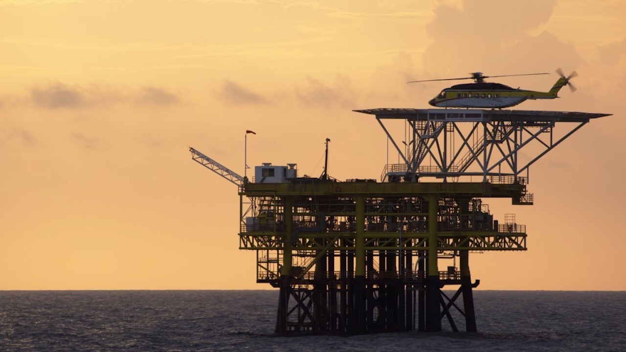 A chopper transports workers to an offshore rig in Malaysia. Photo credit: iStock/claffra.