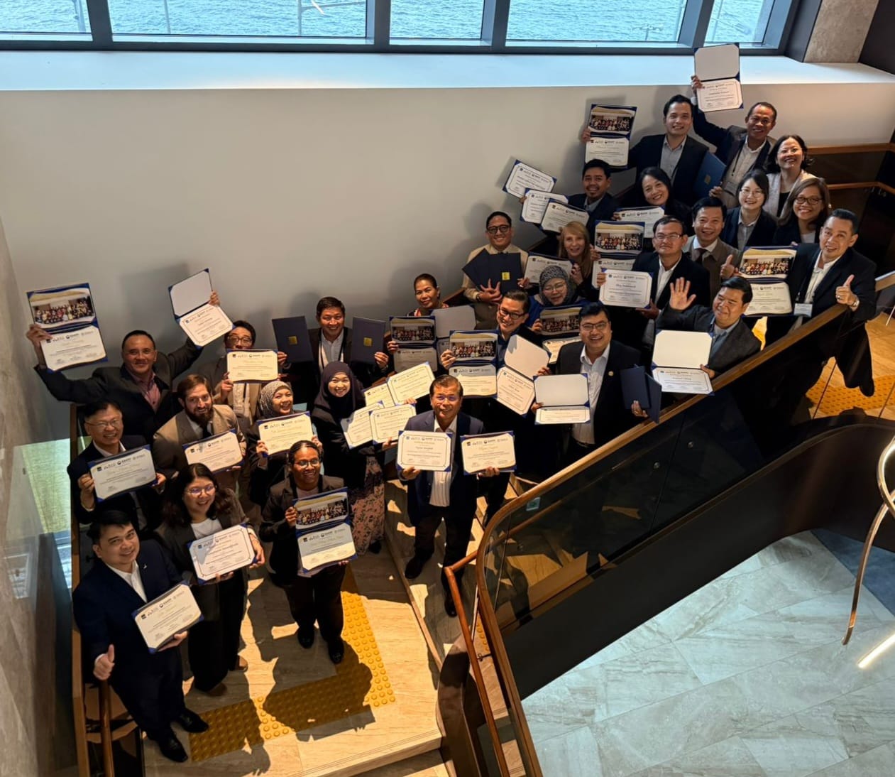 Participants show their certificates after completing the executive learning program. Photo credit: Jordana S Queddeng-Cosme/ADB.