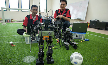 Students in Indonesia posing with the robot they built for their class.