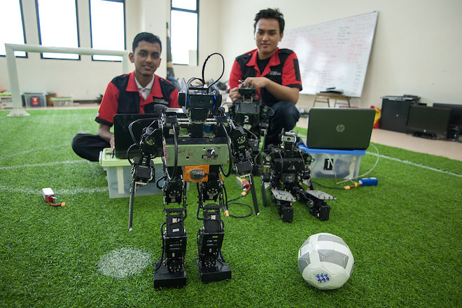 Students in Indonesia posing with the robot they built for their class.