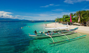 Boat operators wait for their tourists on their boat in Honda Bay in Palawan.