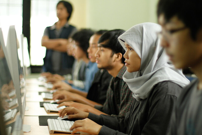 Students in Indonesia working in front of their computers. 