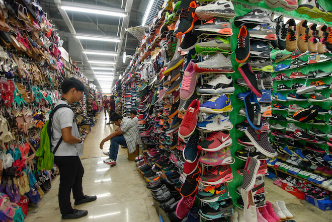 A man browses through shoe racks in a store in the Philippines.