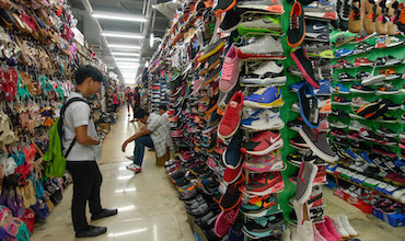A man browses through shoe racks in a store in the Philippines.