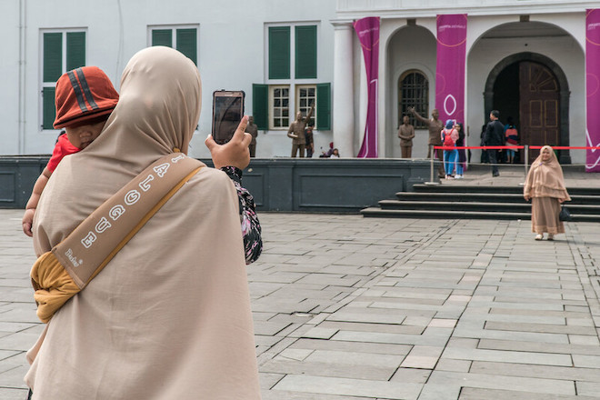 People enjoy themselves at the Fatahillah Square, in the Old Town, Jakarta.