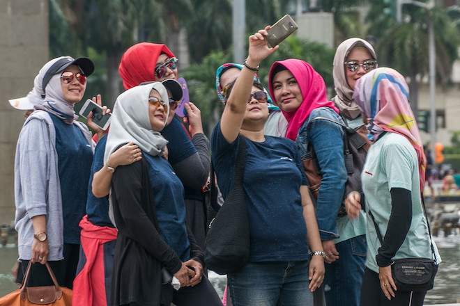 Women take a selfie in Jakarta.