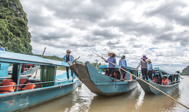 Blue boats transporting tourists going to Phong Nha cave in Viet Nam.