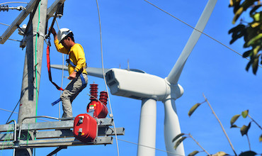 a man working at a wind farm in the Philippines.