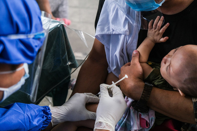 An infant gets vaccinated in the Philippines.