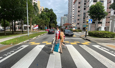 A couple crossing the street at the height of COVID-19 in Singapore.