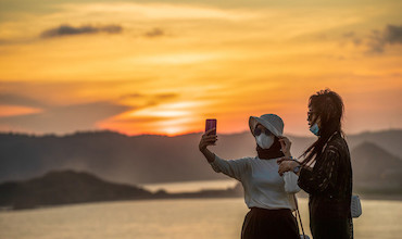 A couple taking a selfie at a tourist site in Indonesia.