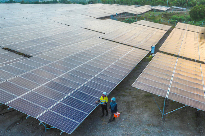 Workers through a solar farm in Indonesia.
