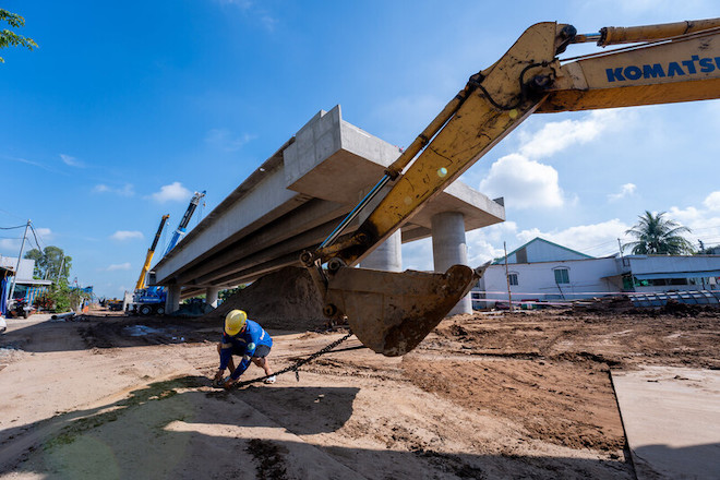 A man working at a bridge construction site in Viet Nam.