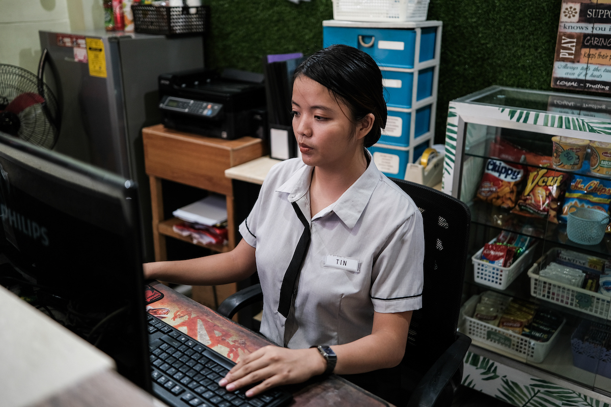 An employee uses a computer in a hotel in the Philippines.