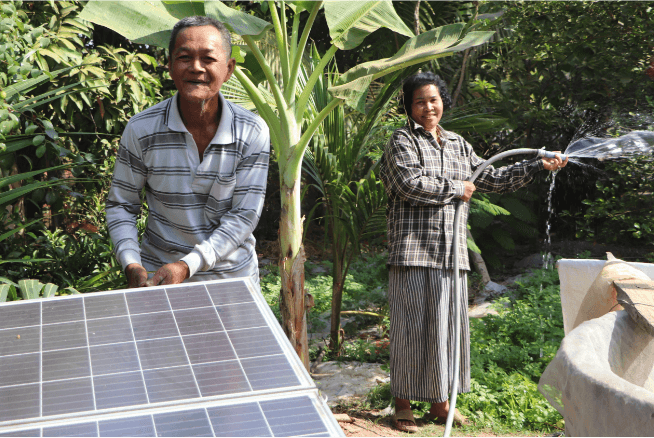 A farmer couple working beside solar panels