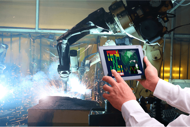 A robotic arm drills while being controlled via a tablet.