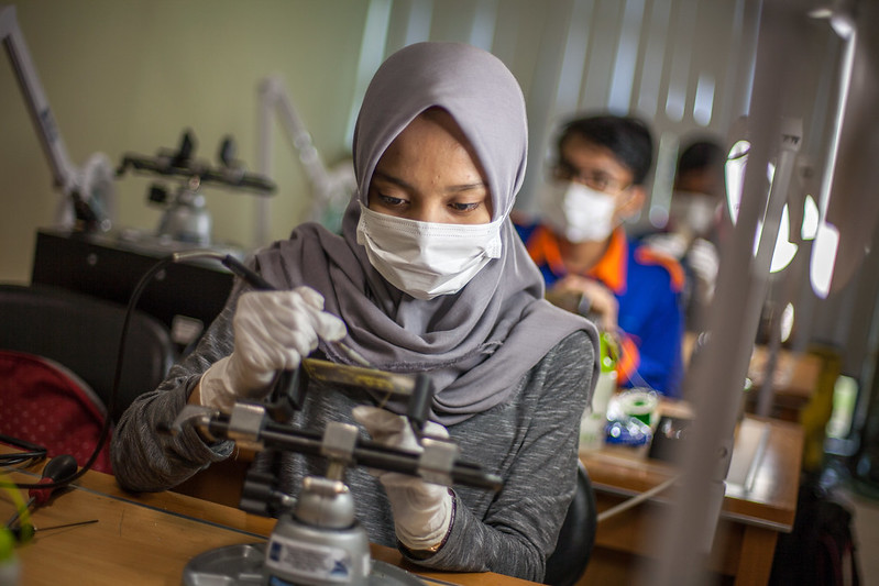 A student attending class at a polytechnic university in Indonesia.