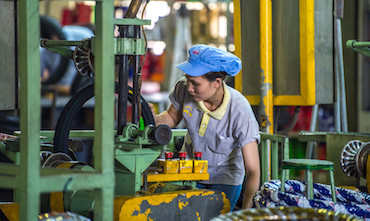 A woman working at a motorcycle tire factory in Viet Nam.