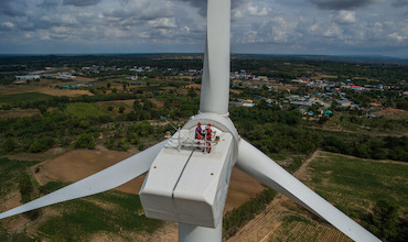Workers doing maintenance work on a wind turbine in Thailand.