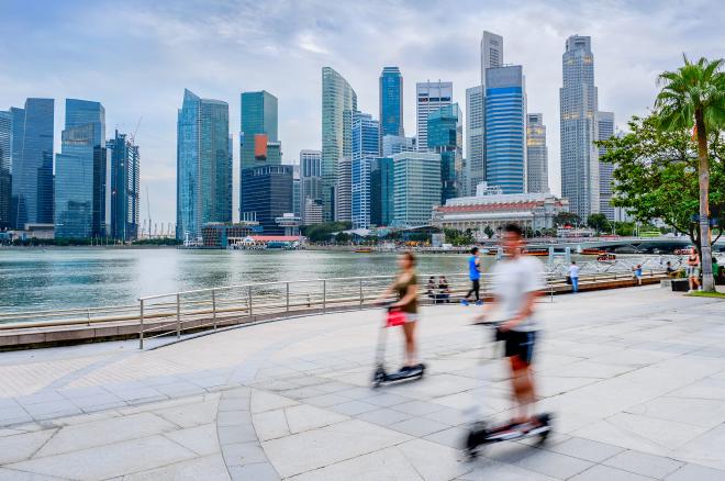 People riding scooters in Singapore.