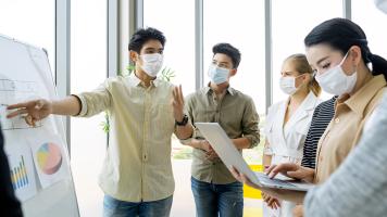 To survive COVID-19, businesses should review their business plans weekly. Photo credit: iStock/pondsaksit.