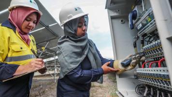 Vena Energy staff Nurul Hidayah and Fatma Mulyana perform operations and maintenance work at Selong in Lombok island, Indonesia.