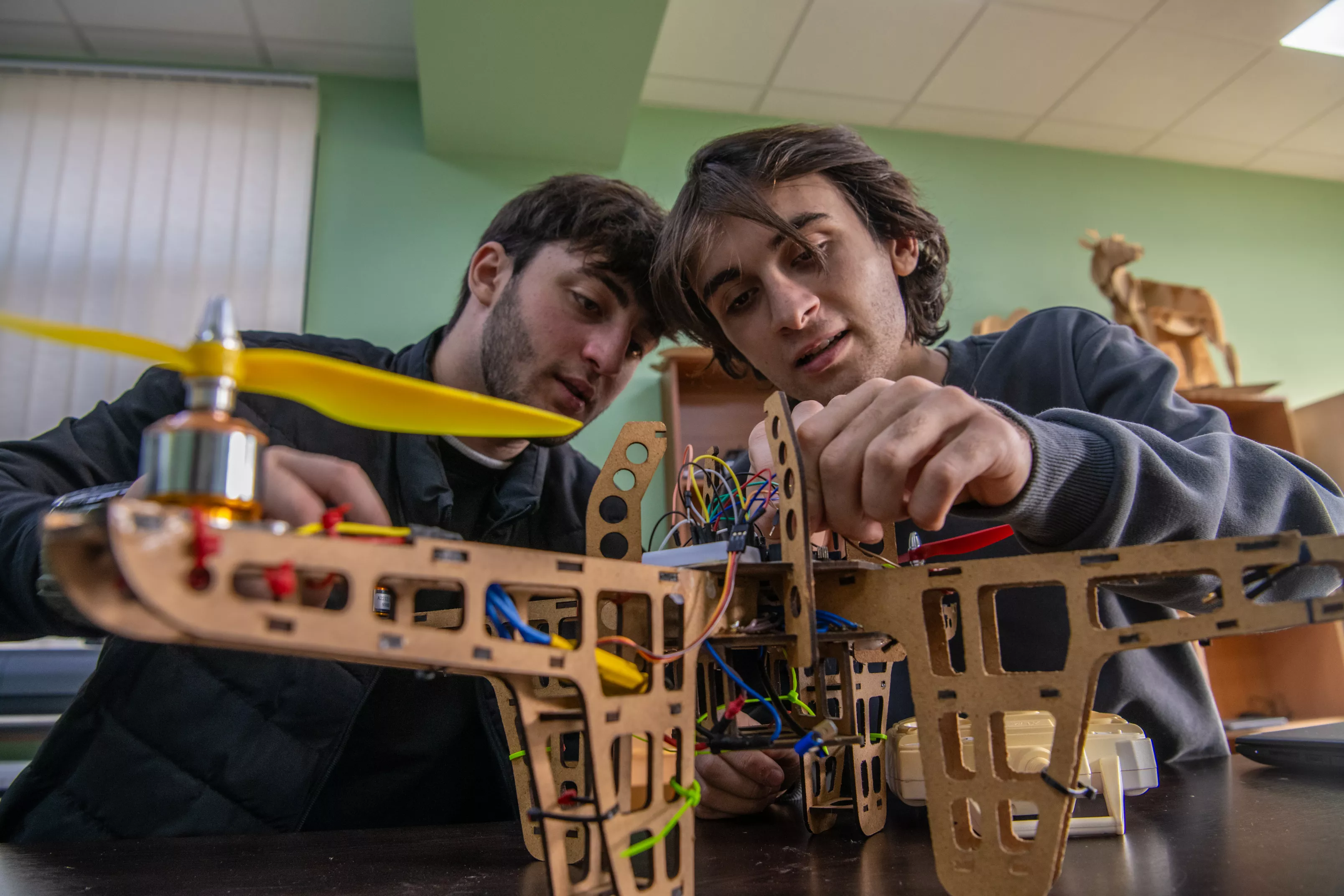 Engineering students study a drone. Photo credit: ADB.