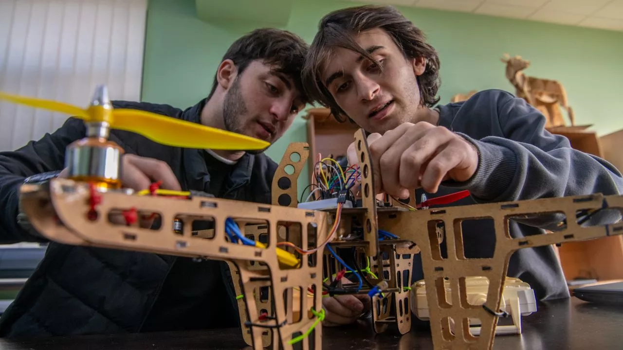Engineering students study a drone. Photo credit: ADB.
