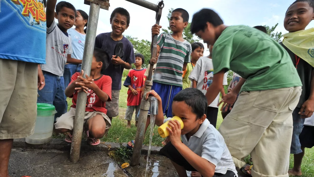 Children gather around a community water pump. Photo credit: ADB.