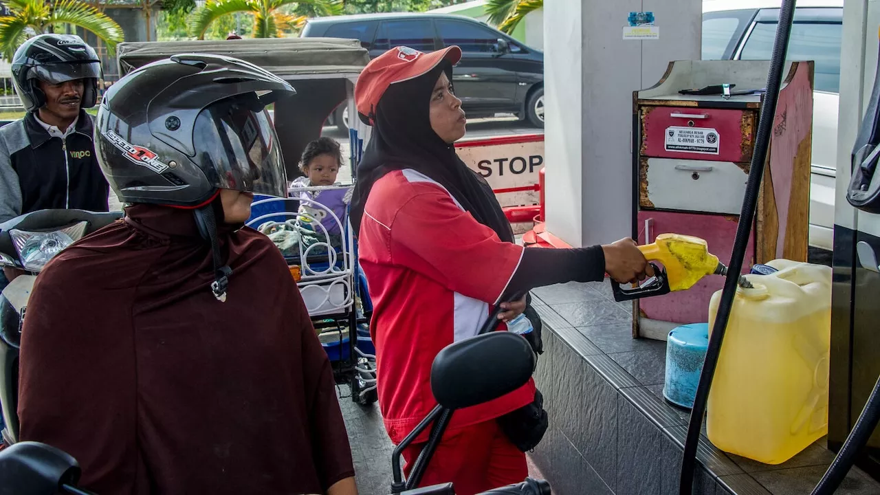 A gasoline station attendant fill up a fuel container. Photo credit: ADB.