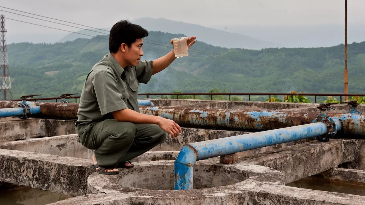 A man inspects water quality at a plant. Photo credit: ADB.